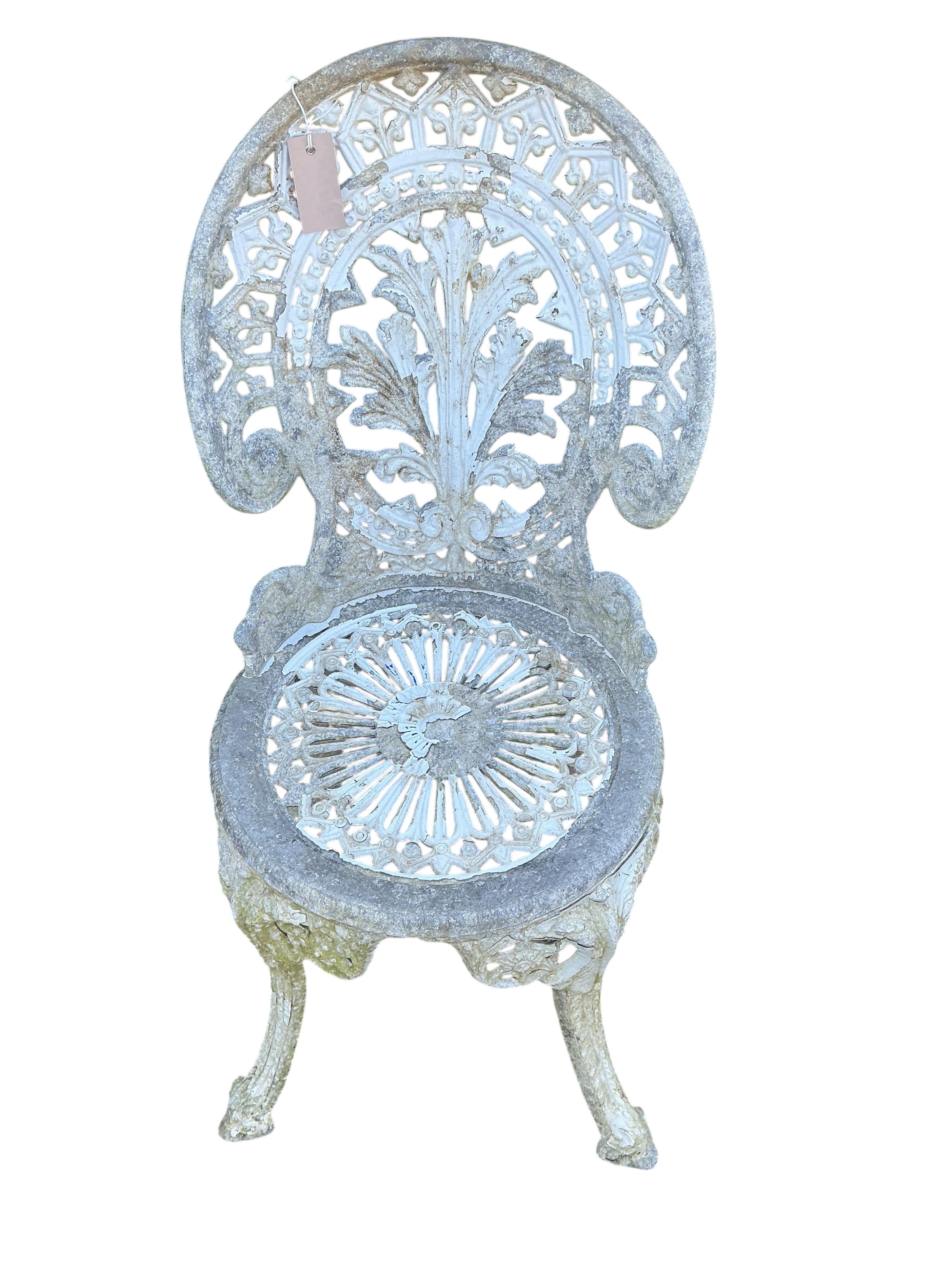A Victorian style circular painted aluminium garden table, diameter 66cm, height 71cm and two similar garden chairs